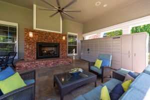 One Bedroom Apartments for Rent in Conroe, TX - Covered Outdoor Seating Area with Fireplace & Package Hub   
